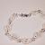 Two rows of white rubber Orings bracelet  $12.00