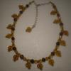 Gina's first (and only) creation. Amber/gold glass leaves and round brown glass beads necklace.